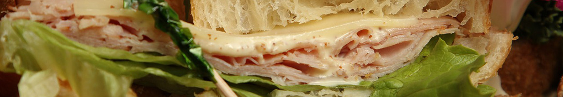 Eating Deli Sandwich at Paul's Deli restaurant in Westminster, CA.
